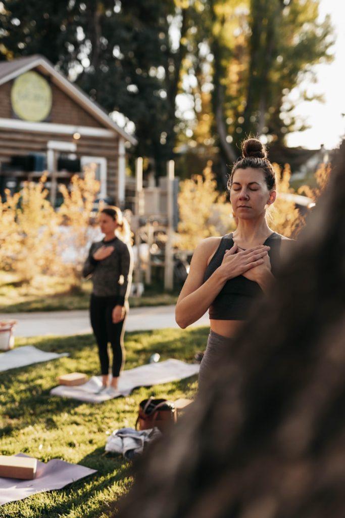 Photo by Marea Wellness a group of people doing yoga in a park